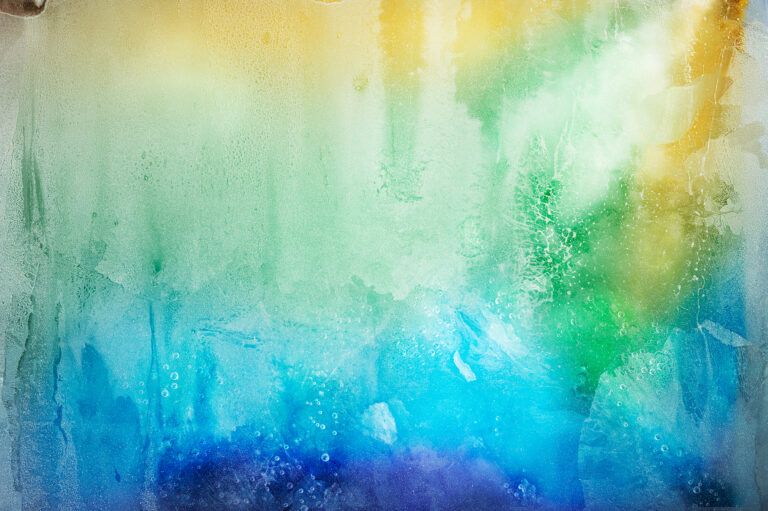 Abstract gradient of yellow, green, and blue light refracting through i