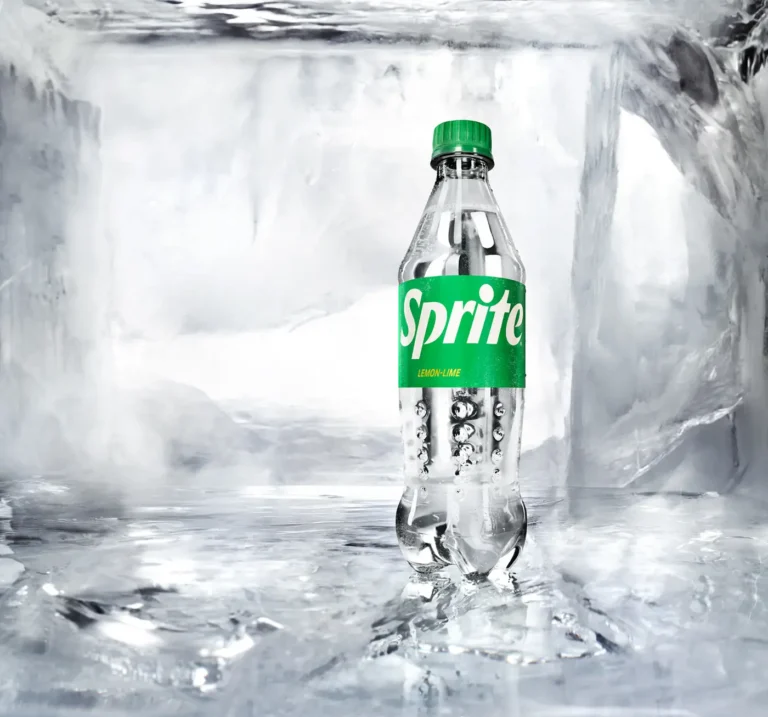 A Sprite glass bottle encased in a solid block of clear, cracked ice.